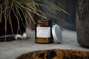 Soy candle in amber mason jar, lid to the side. Link: shop by scent